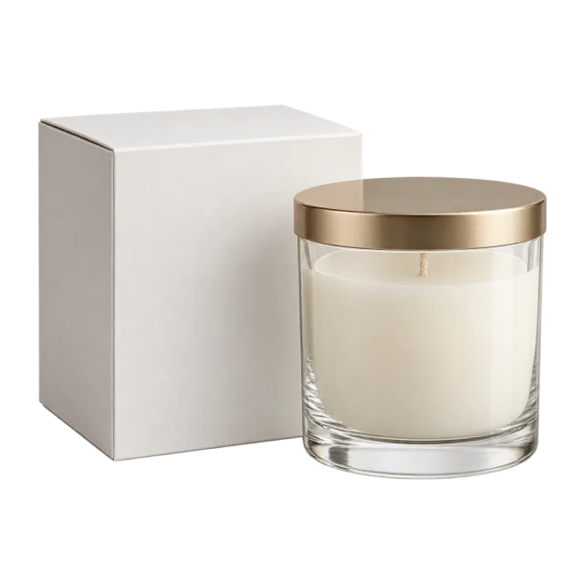 A white candle in a clear jar with a gold-colored lid beside a blank white box
